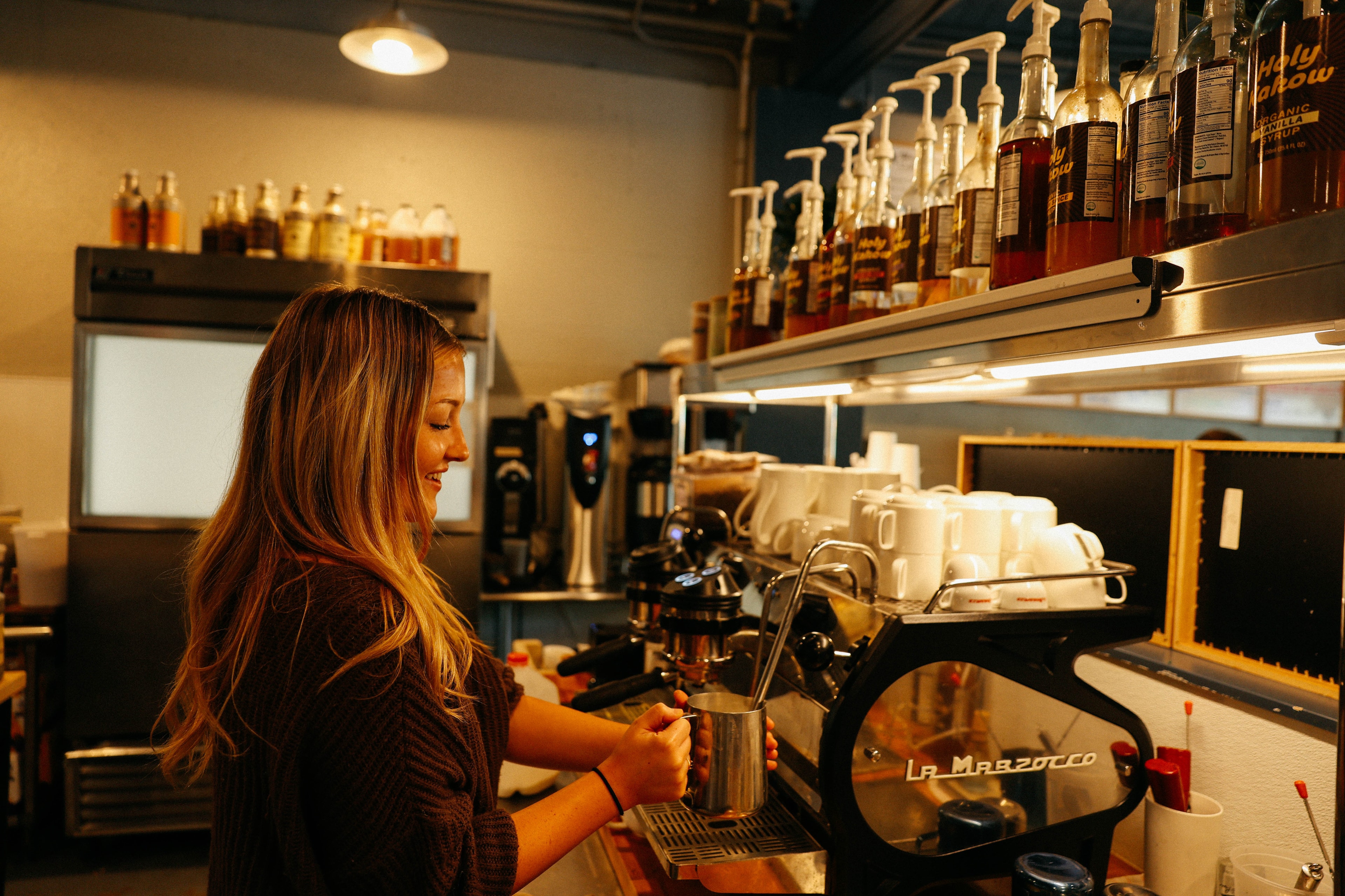 Barista steaming milk on a La Marzocco at Bodhi Coffee